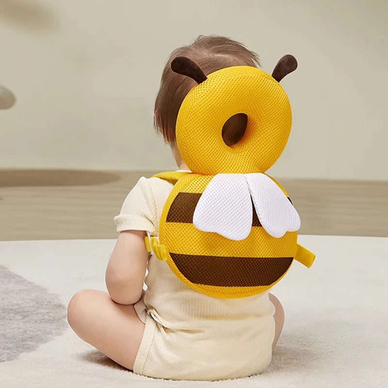 Child wearing a bee-themed headband and outfit on a neutral background