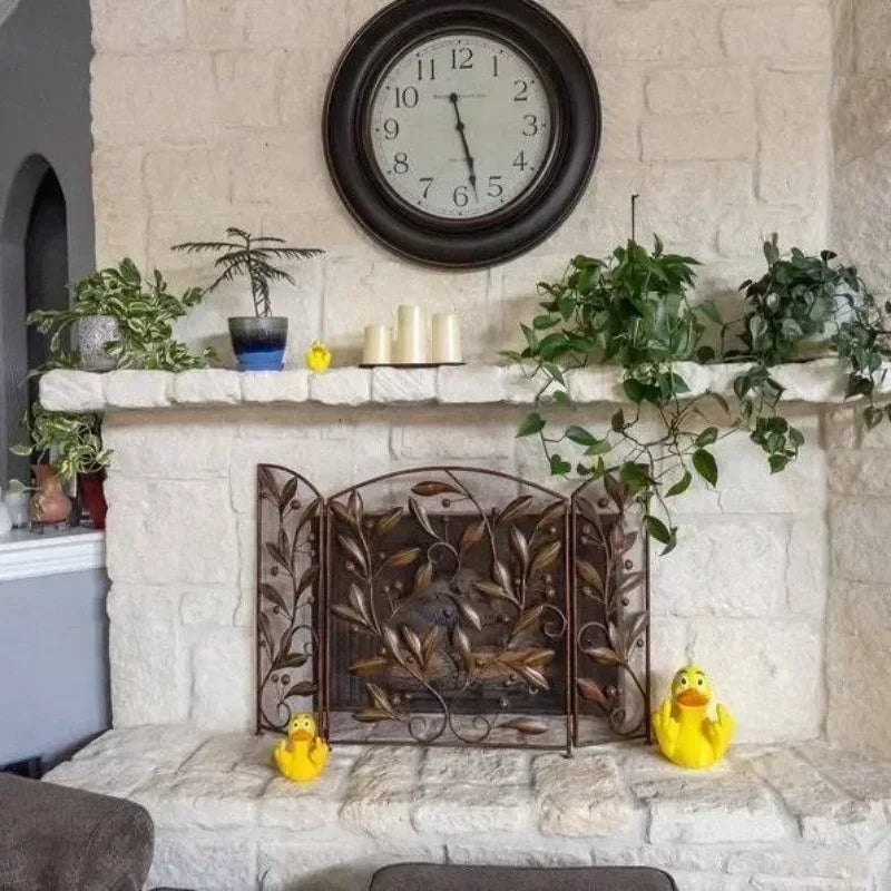 Decorative fireplace with a clock above, plants on the mantel, and rubber ducks on the hearth.