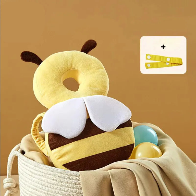 Bee-shaped pillow with a blanket and toys on a beige background, featuring the Aibedila brand.