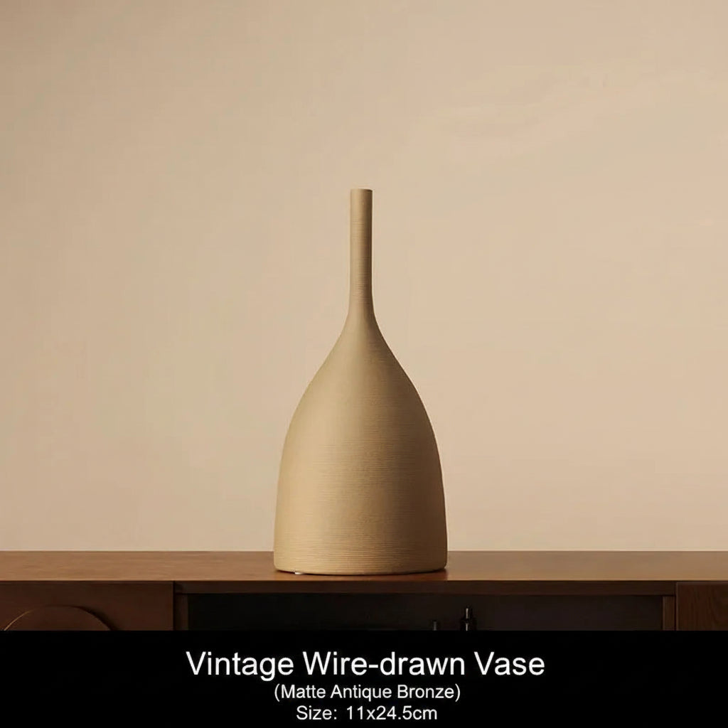 Matte Antique Bronze Beige vase on a wooden surface with a beige background