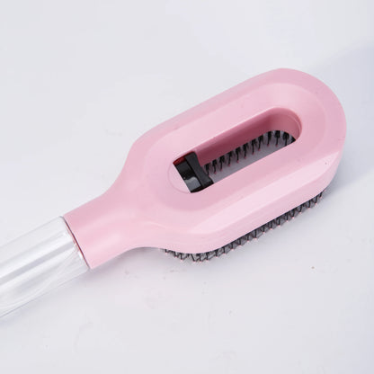 Pink brush with black bristles on a white background