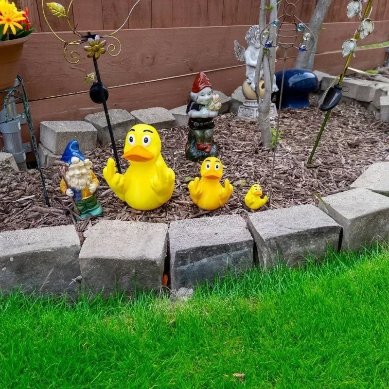 Garden scene with rubber ducks and gnomes on a stone border.