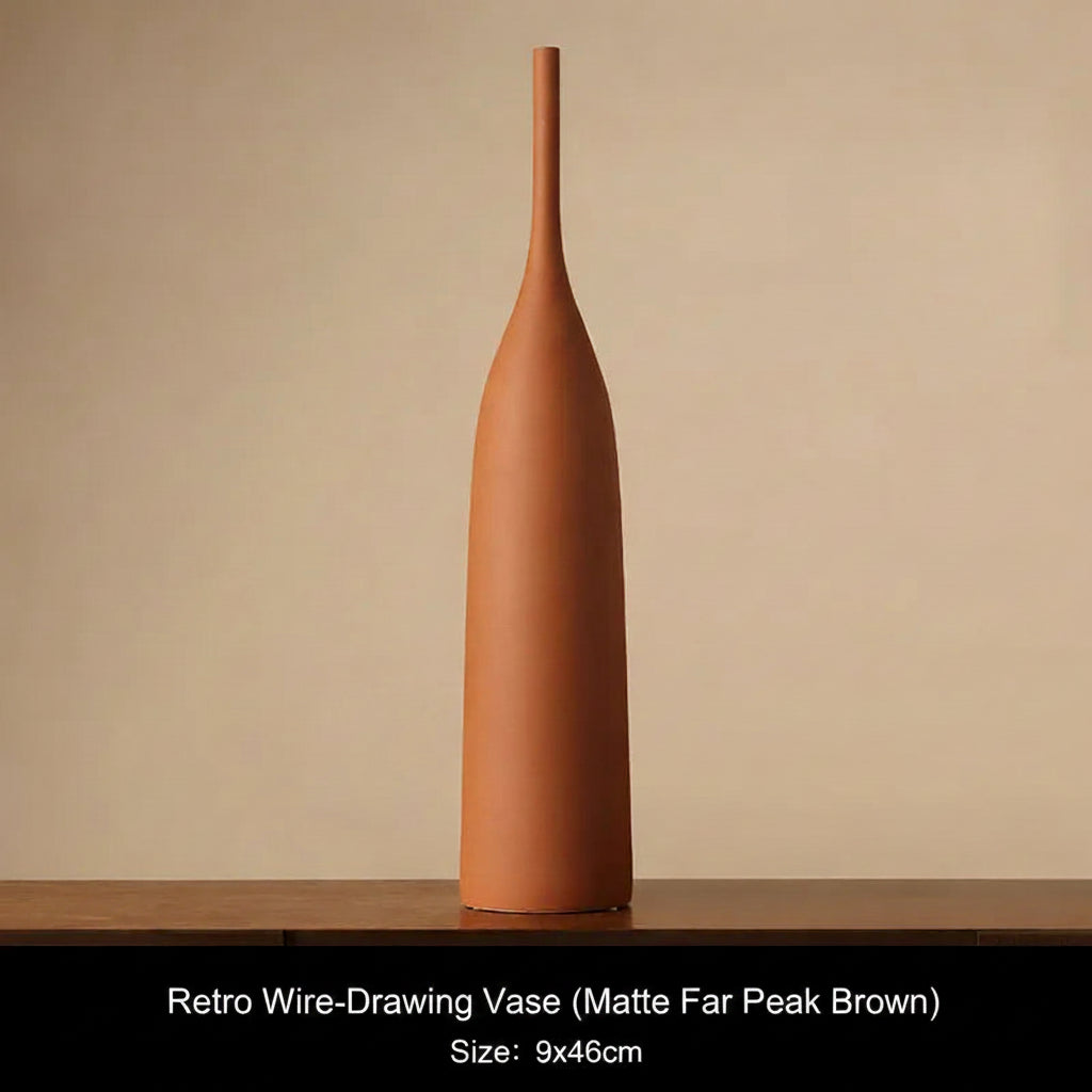Matte Far Pearl Brown Terracotta-colored vase on a wooden surface with a beige background