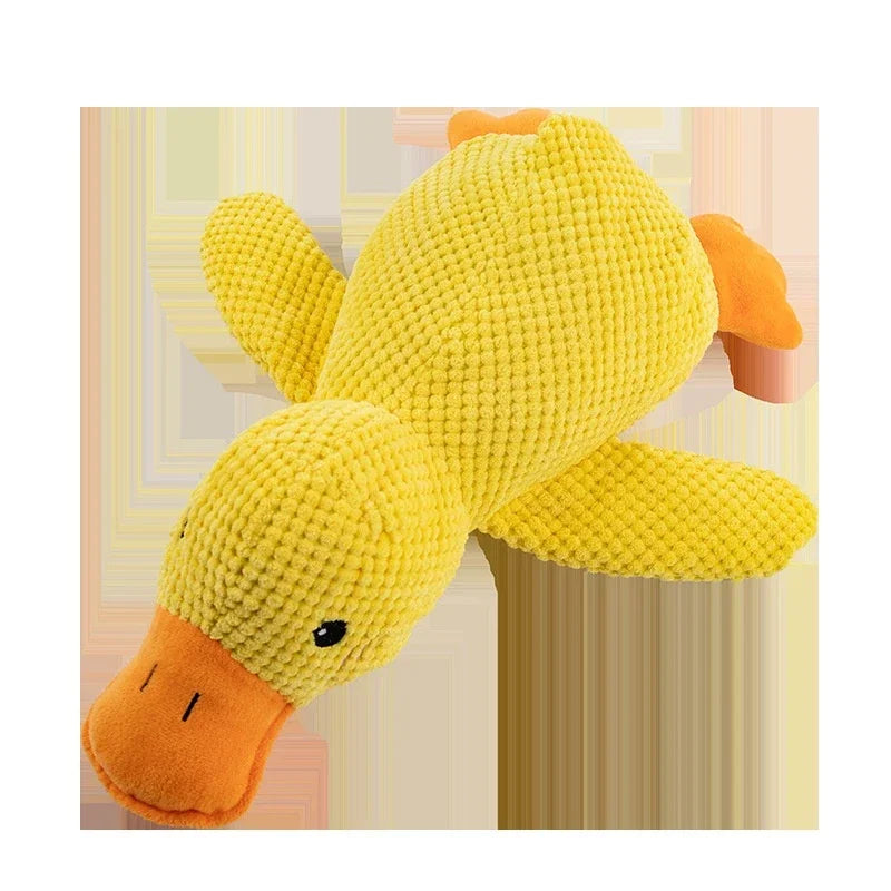 Yellow plush duck toy on a light pink background