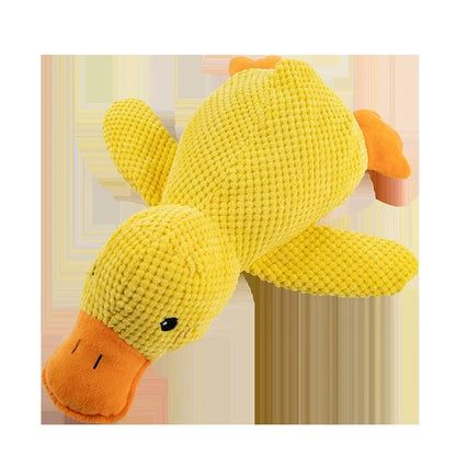 Yellow plush duck toy on a light pink background