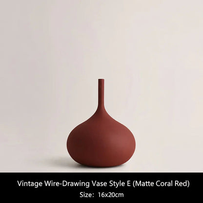 Matte Coral Red ceramic vase on a light beige background 
