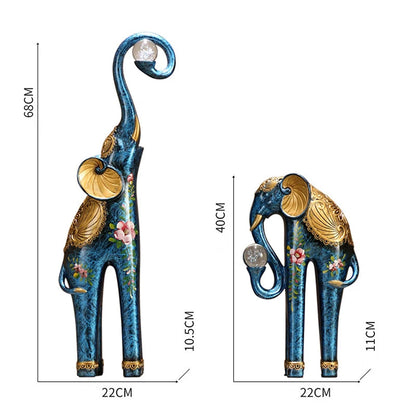 Two decorative elephant statues with measurements on a white background