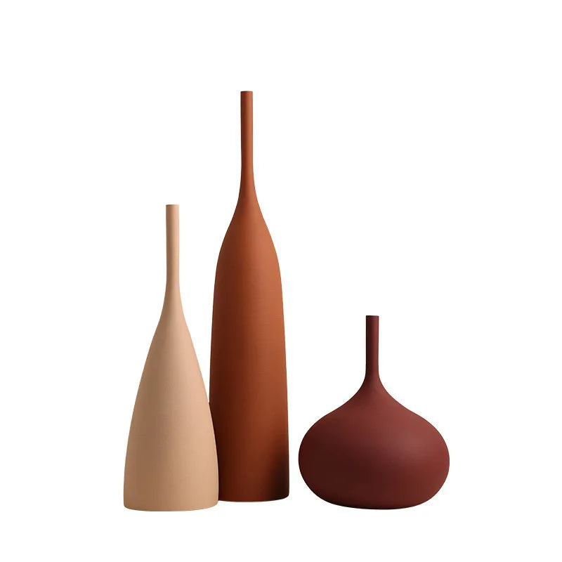 Three ceramic vases in different colors on a white background