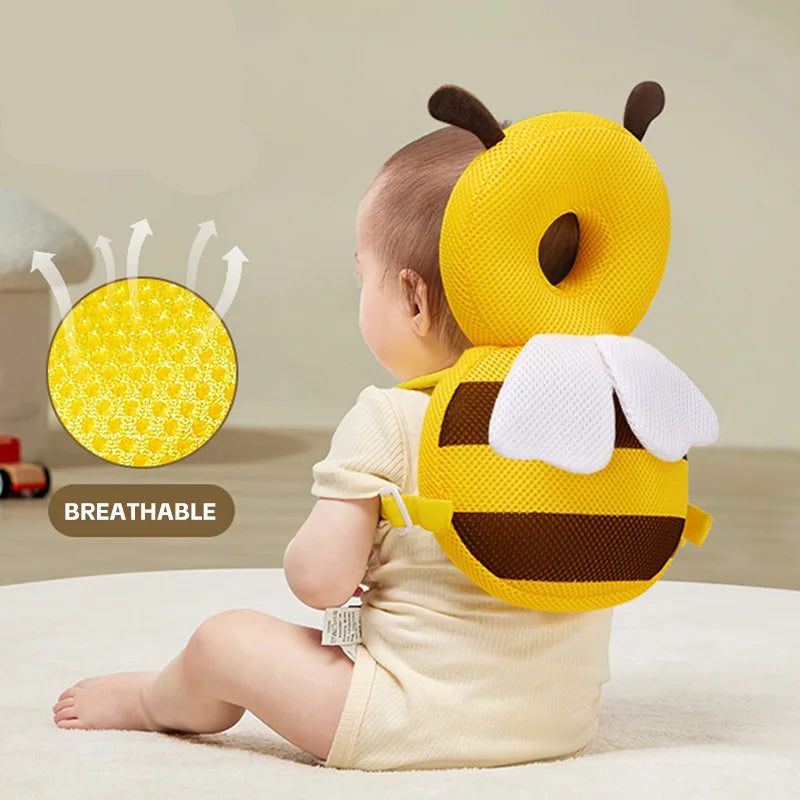 Baby wearing a yellow bee-shaped pillow with Aibedila logo and breathable feature illustration.