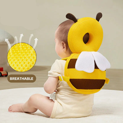 Baby wearing a yellow bee-shaped pillow with Aibedila logo and breathable feature illustration.