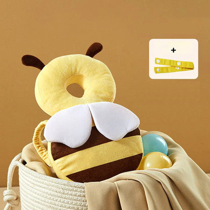 Bee-shaped pillow with a blanket and toys on a beige background